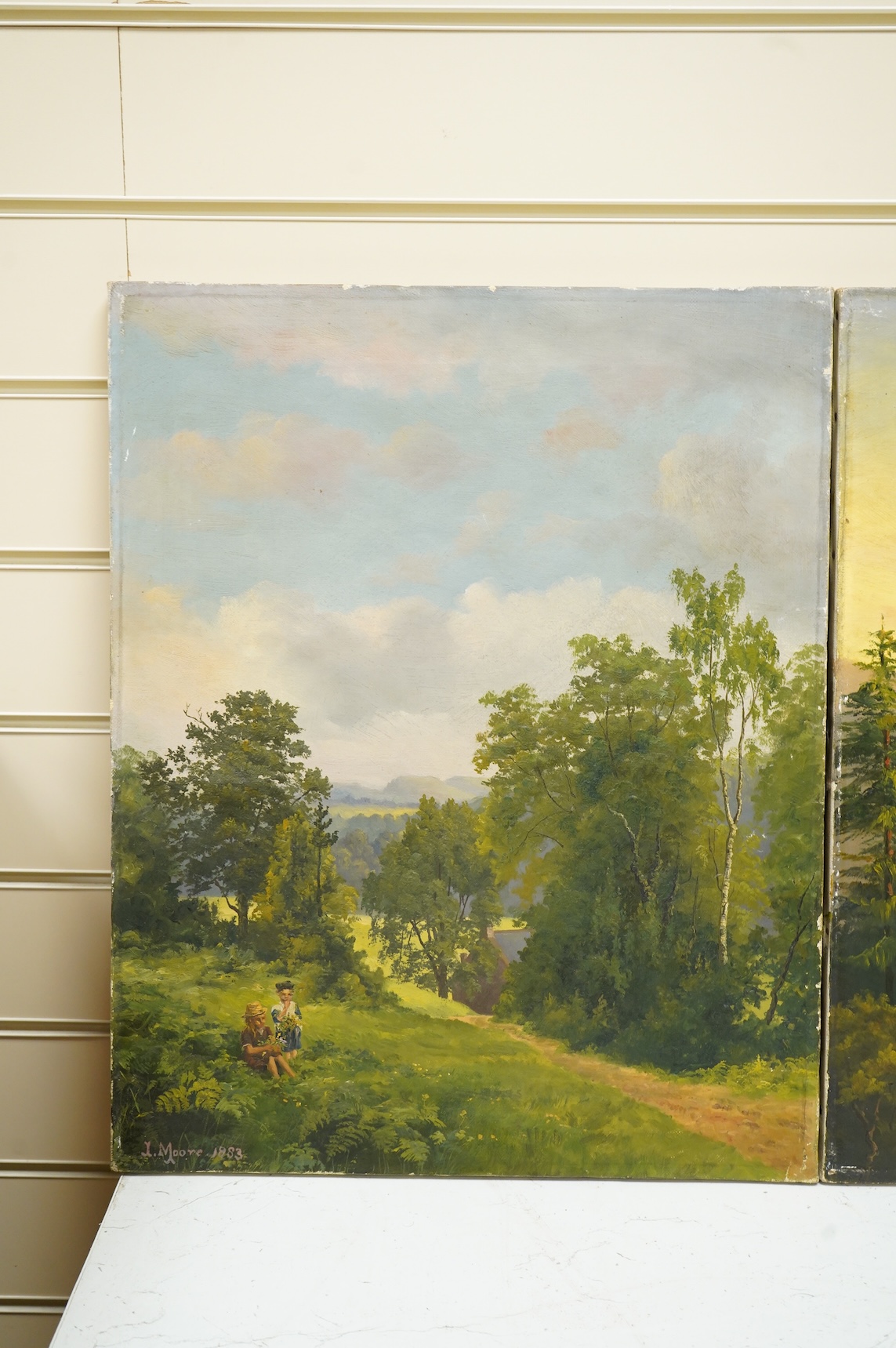 J. Moore, Two children on a hillside, signed and dated 1883, oil on canvas, together with a similar example, Riverscape with mountains beyond, pair of oils on canvas, unframed, each 50 x 40cm